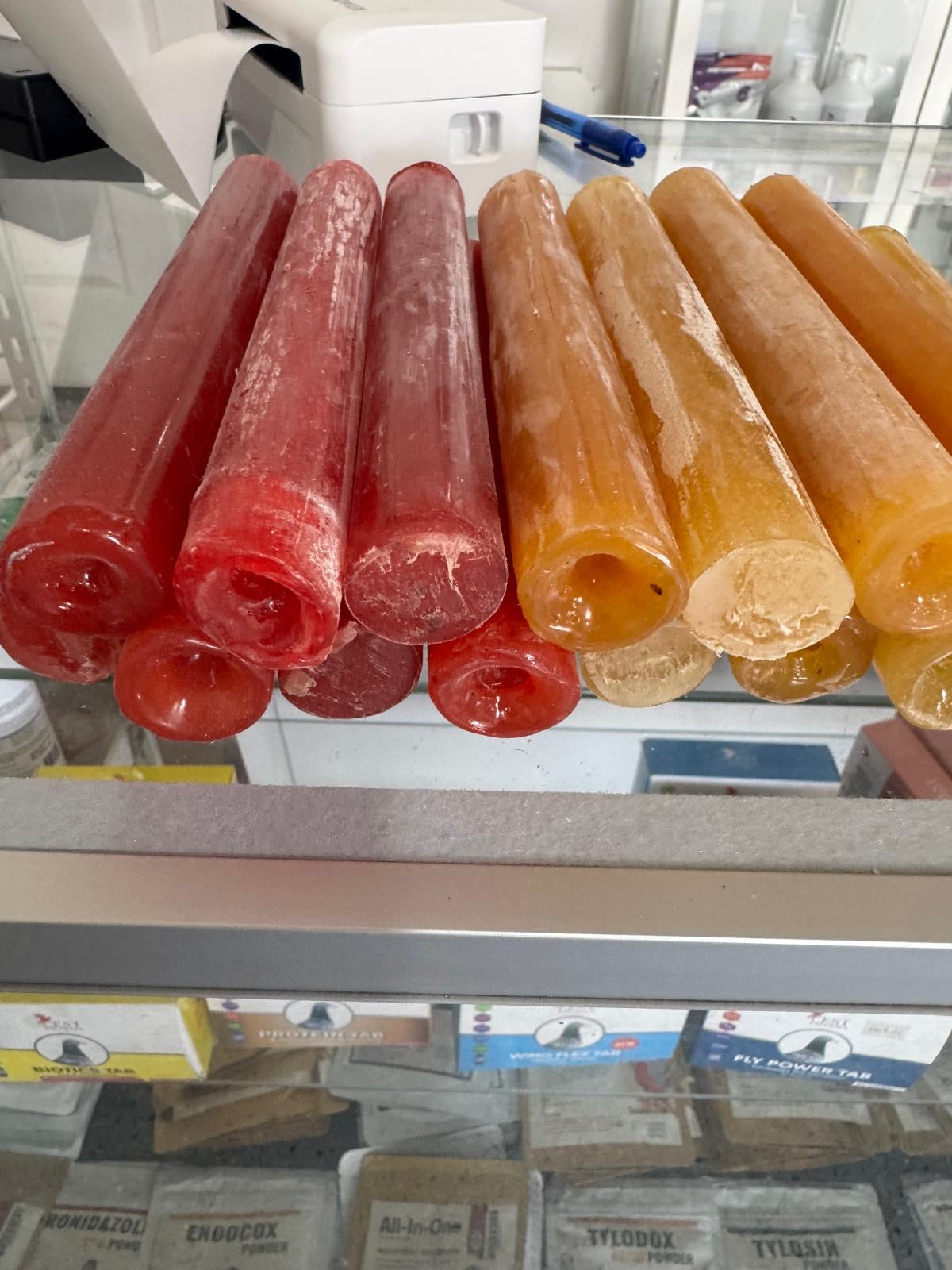 Red, yellow, and black wax glue for roosters